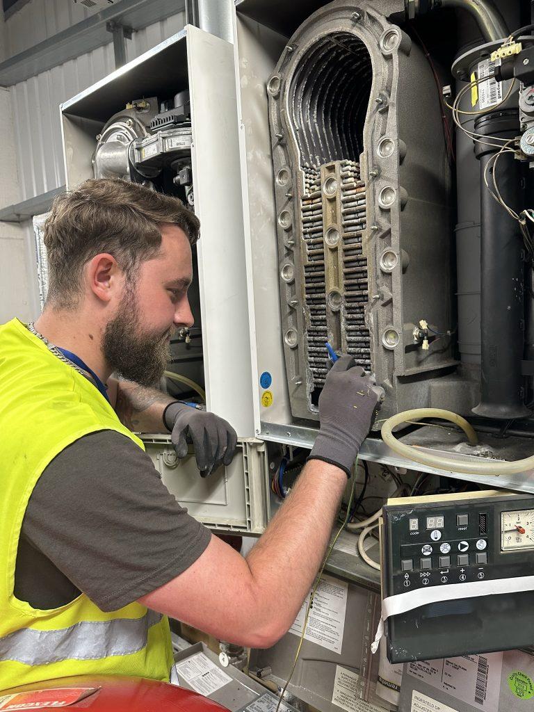 HMS Engineer showing an open Remeha gas boiler.