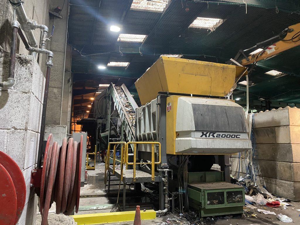 Photo shows a large industrial shredder used for waste recycling.