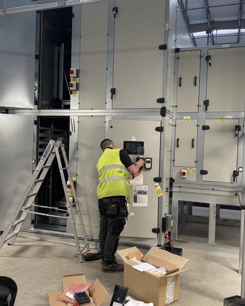 Photo of an engineer servicing an Air Handling Unit.