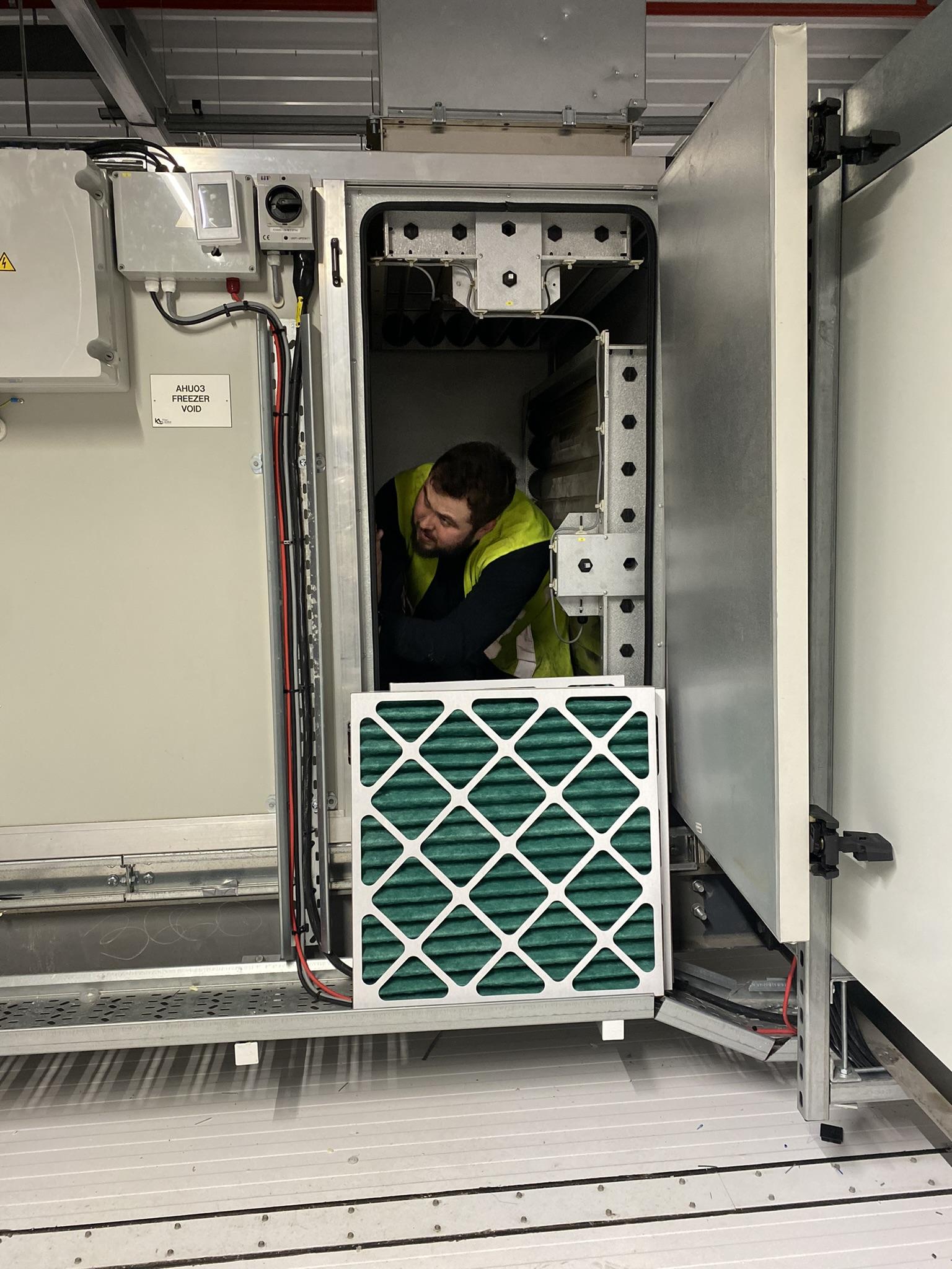 Photo showing a filter being changed in an Air Handling Unit.